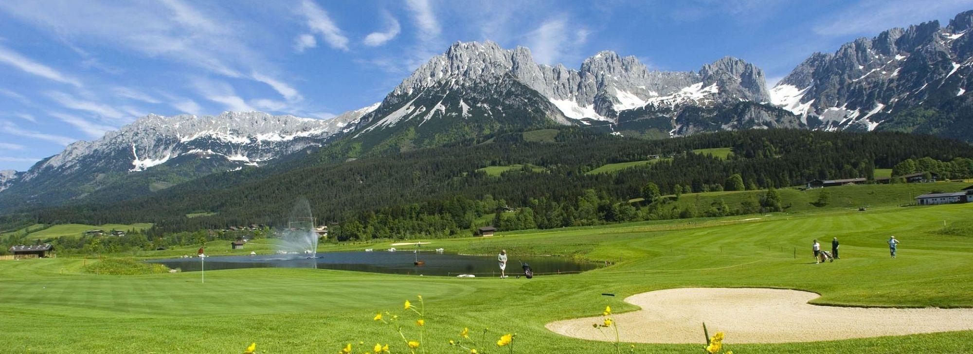 Panoramic view of golfers enjoying their round on well maintained fairways