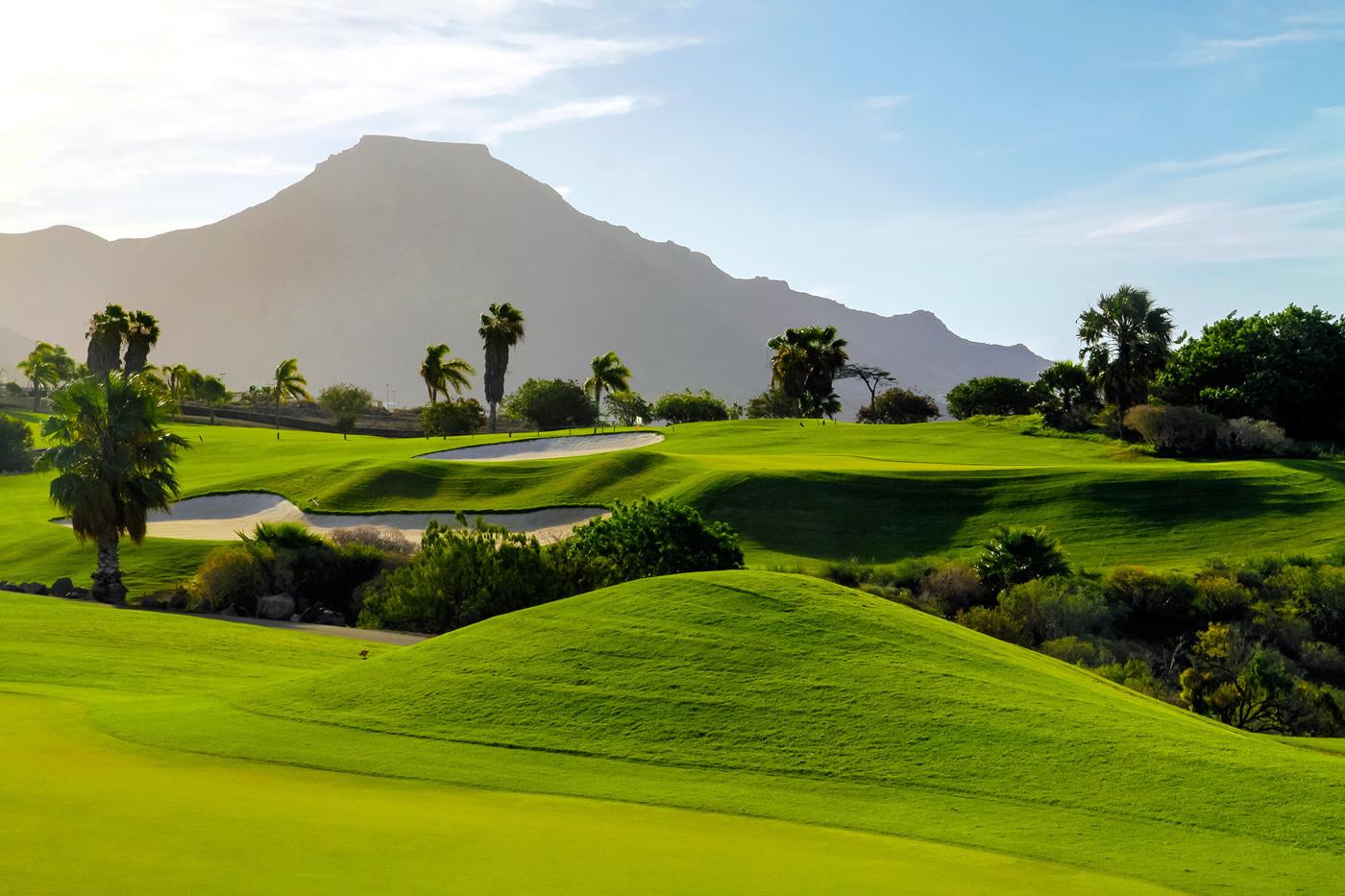 Showing the undulations of the course with the mountains in the background
