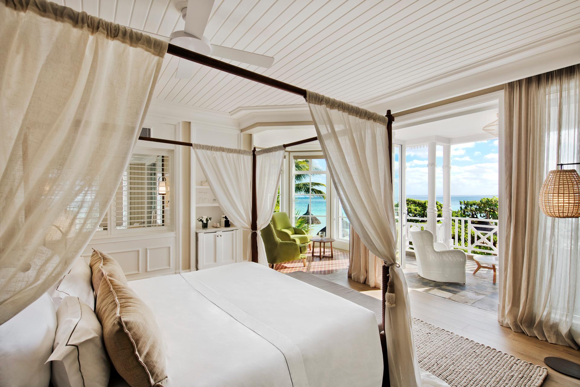 Double bed room at the resort with a grand bed frame and balcony views of the ocean