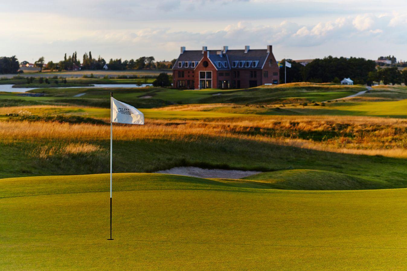A golf green with the clubhouse visible in the distance.