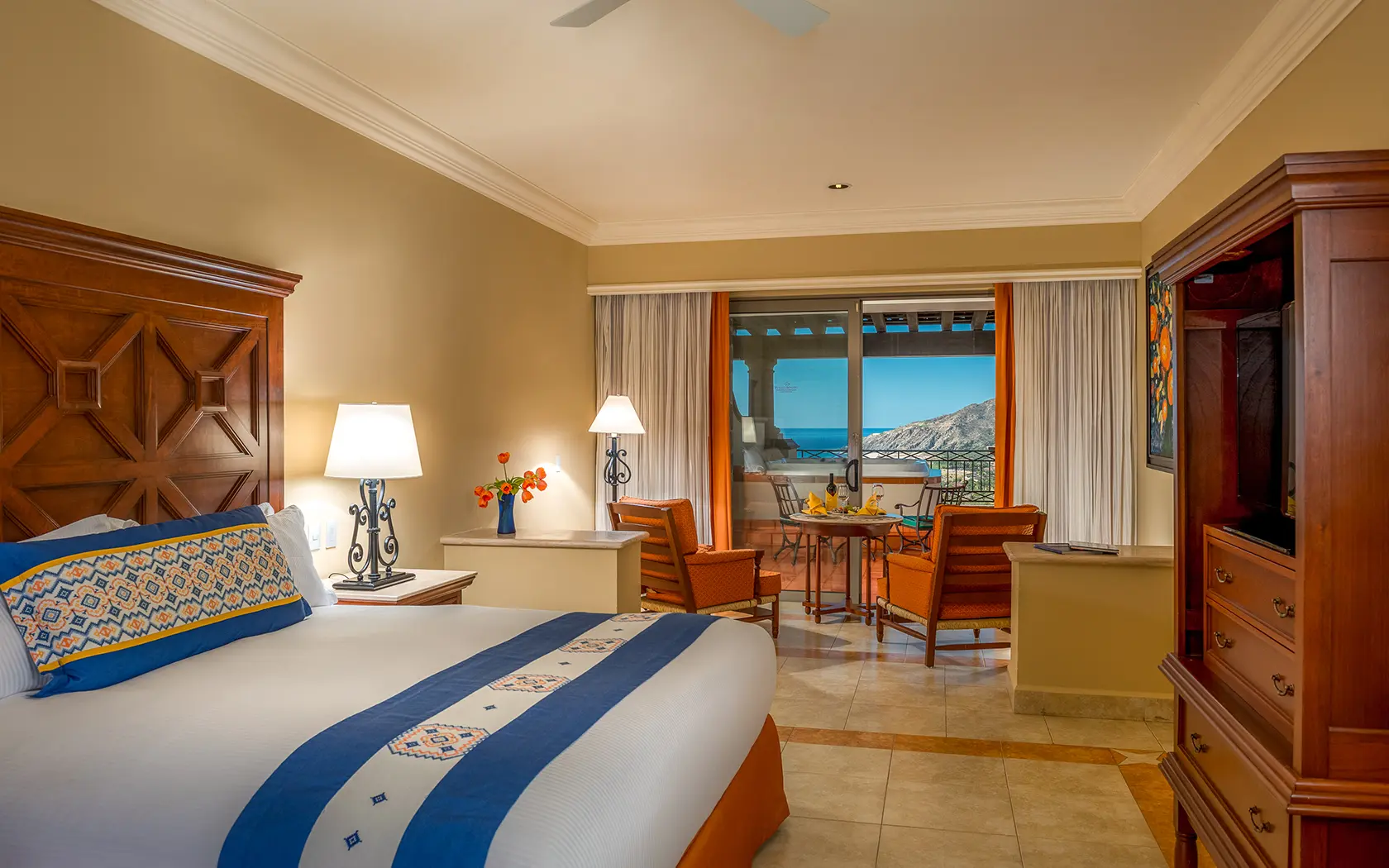 Double bed room at Pueblo Bonito Los Cabos Resort with balcony views of mountains and the ocean