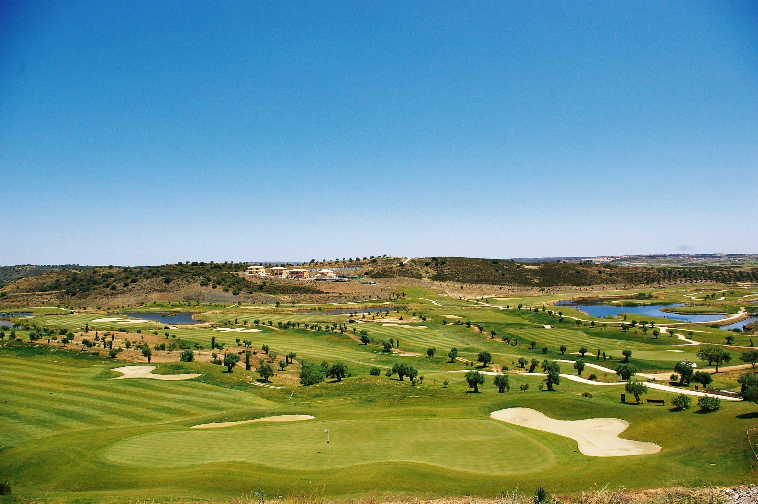 Undularing green in the foreground with manicured fairways behind