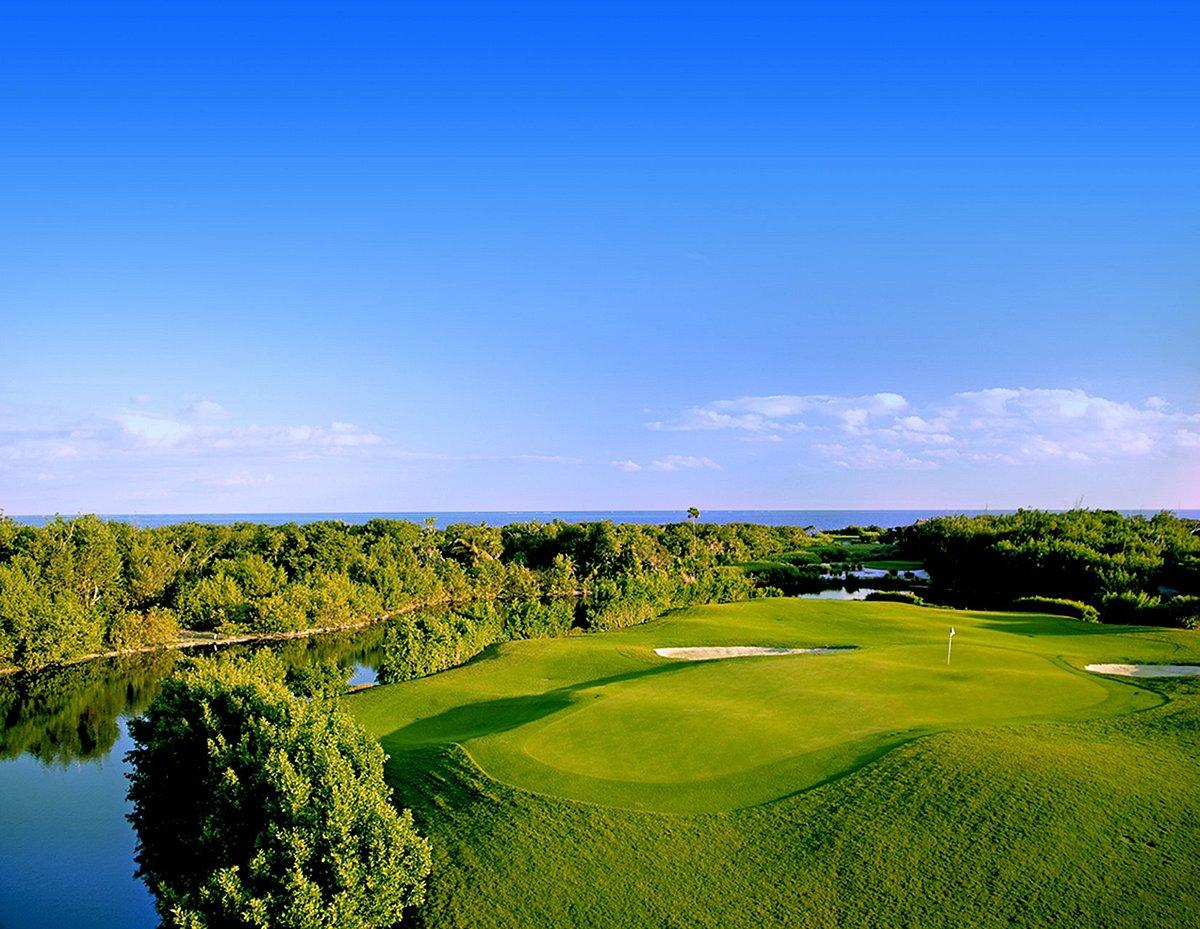 Panoramic view of the sun shining down on a well-maintained green