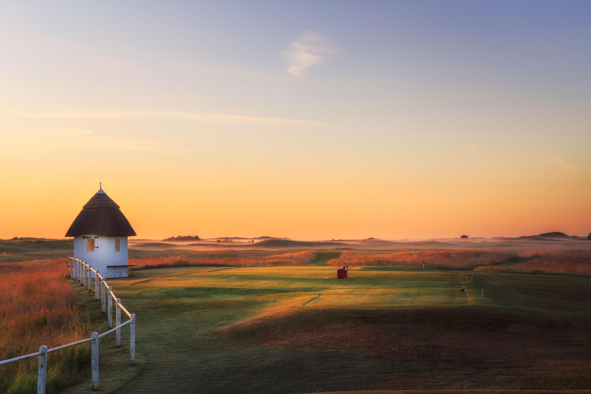 Sun setting over the course enhancing its yellow rough