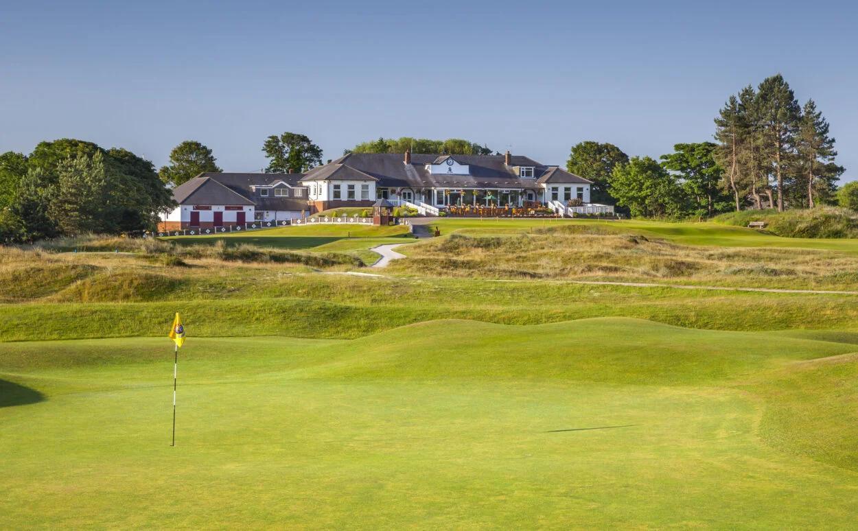 Southport & Ainsdale Golf Clubhouse looking out onto the manicured green and hilly landscape