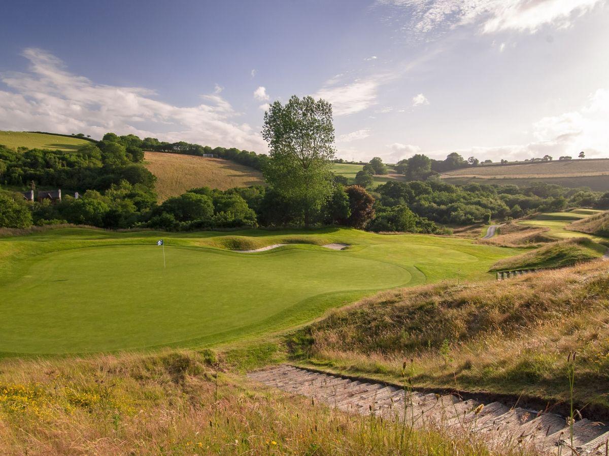 The green with a sand bunker strategically placed