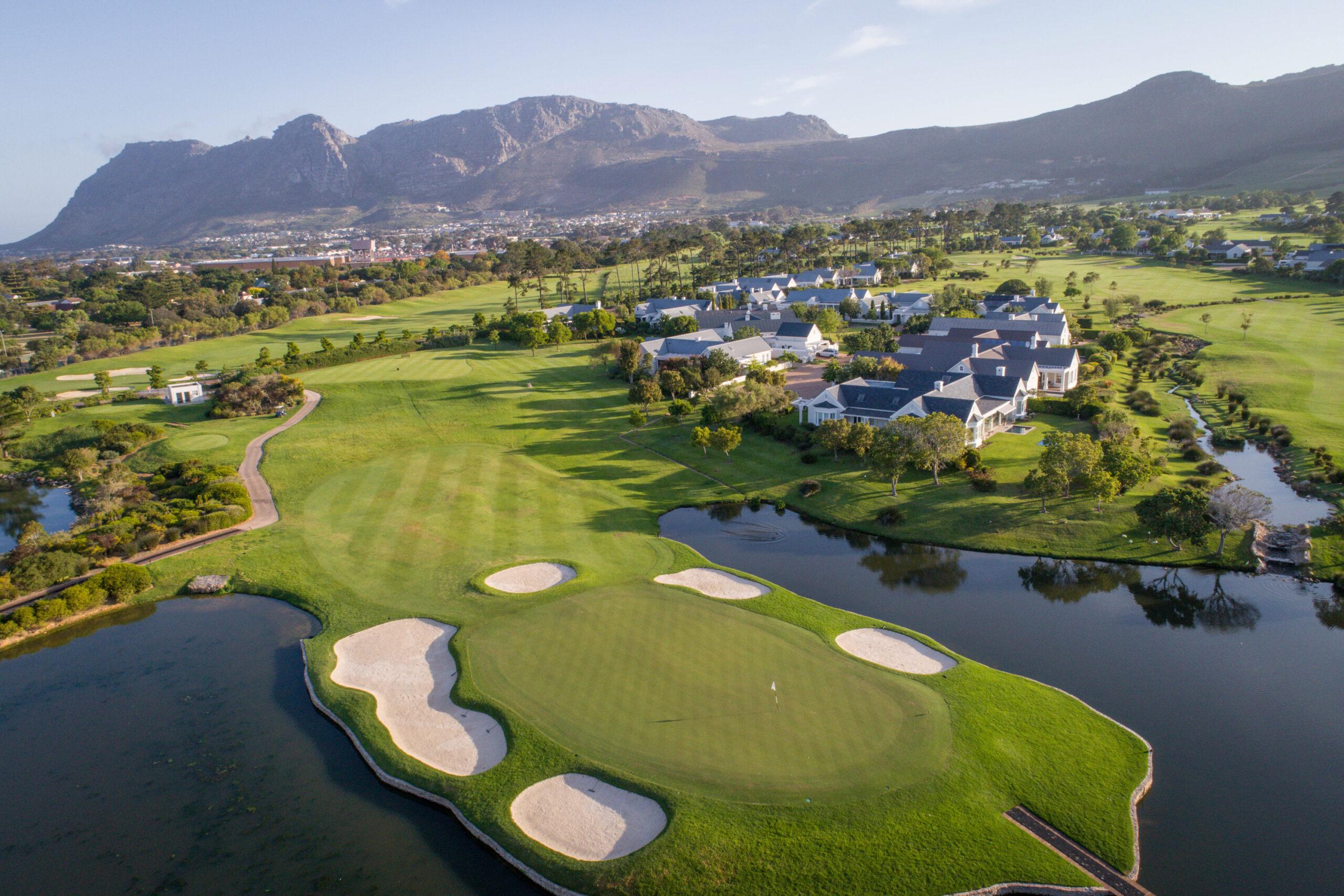 Overhead view of a smooth green surrounded by sand bunkers and water