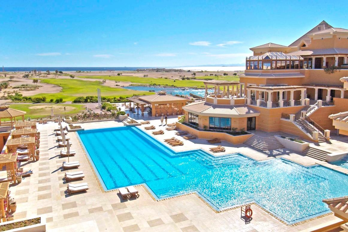 Overhead view of the swimming pool surrounded by sunbeds