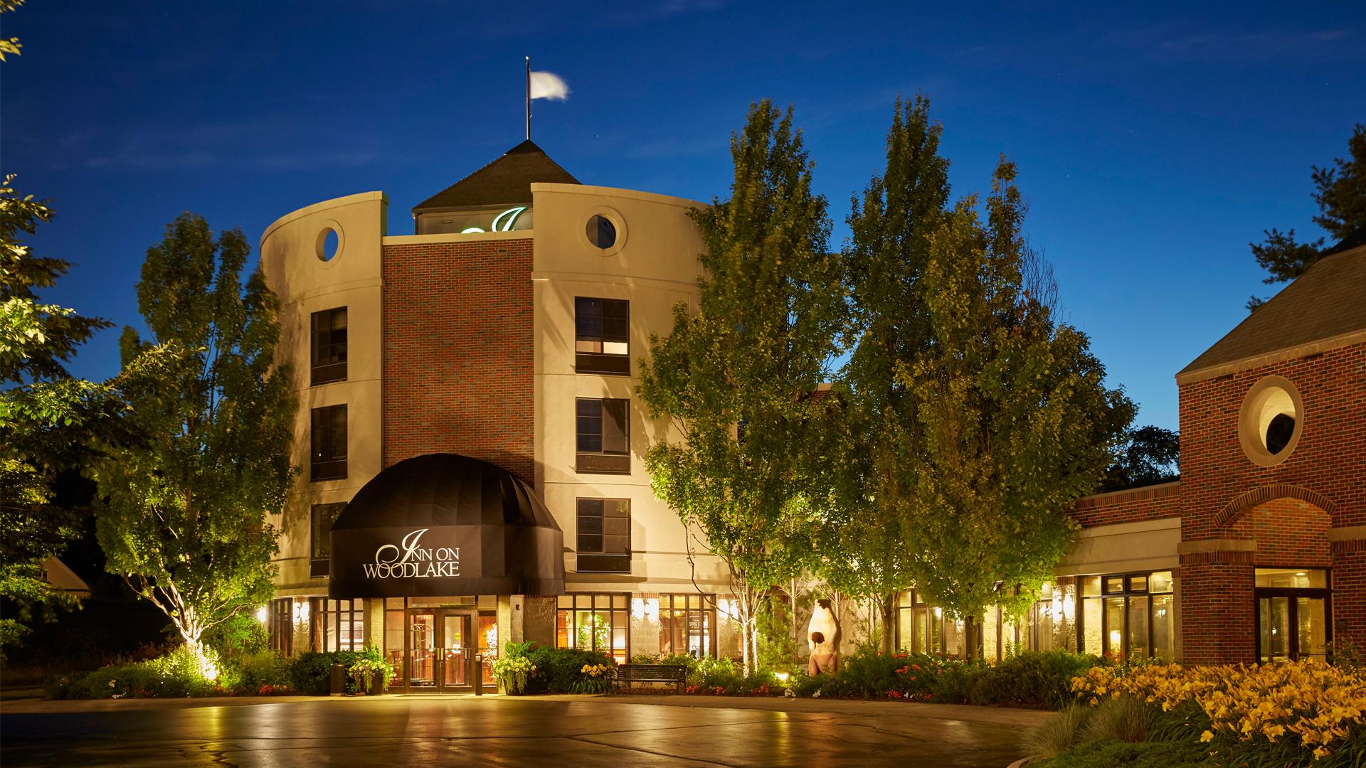 The Inn on Woodlake entrance warmly lit at night.