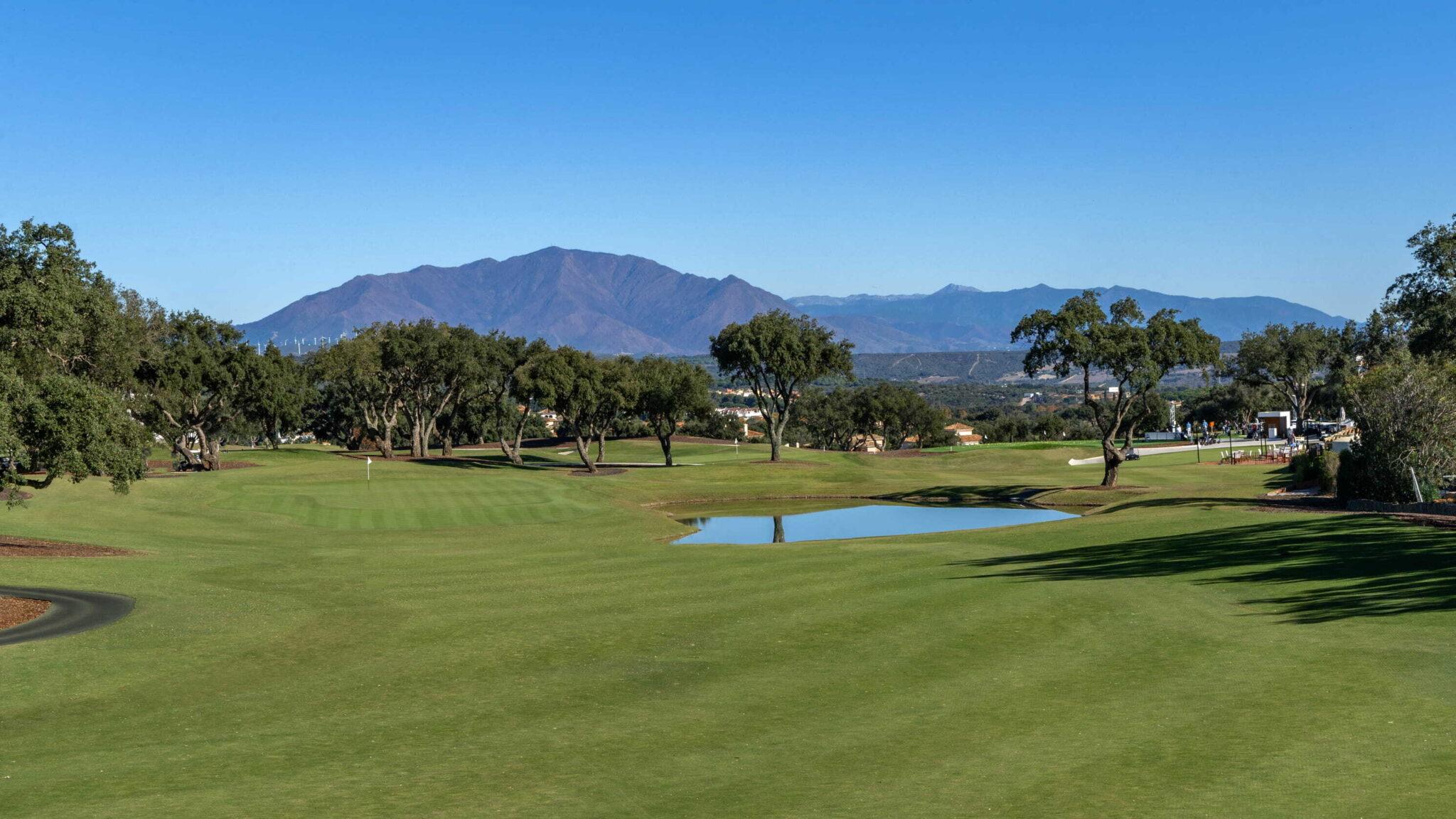 Fairway and green with mountains in the background