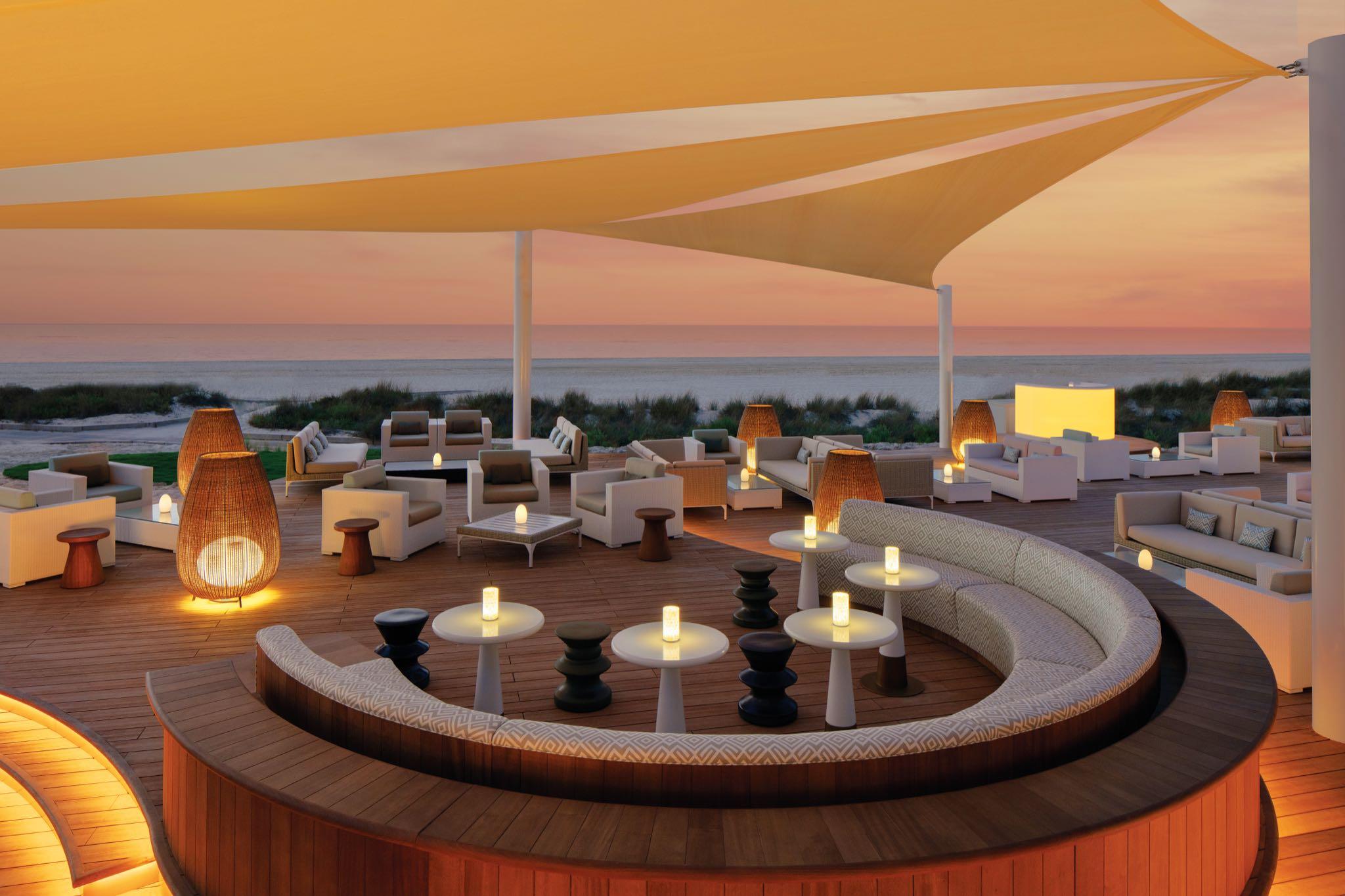 An outdoor lounging area at sun set