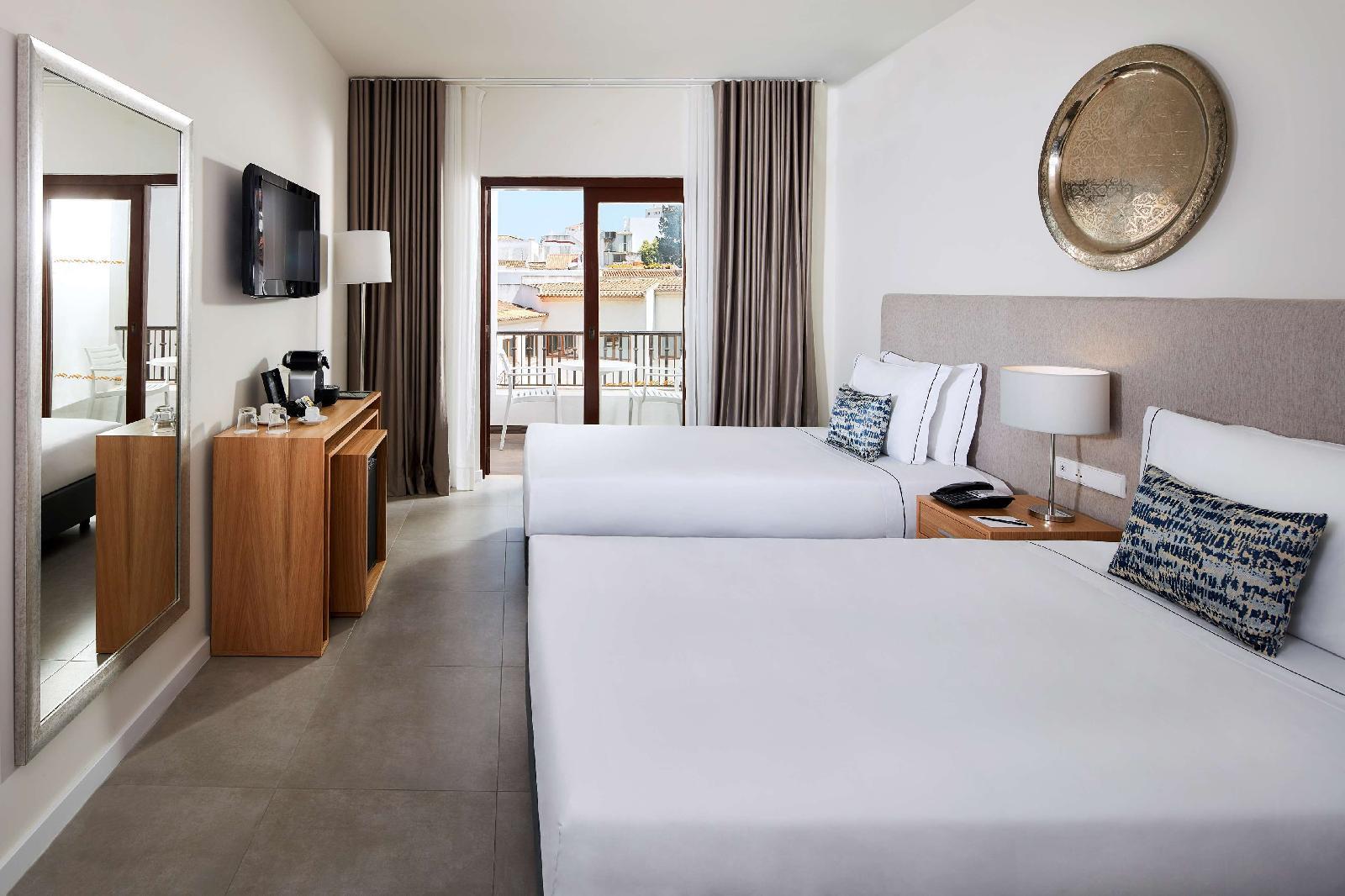 Two twin beds in a Twin Room with a balcony