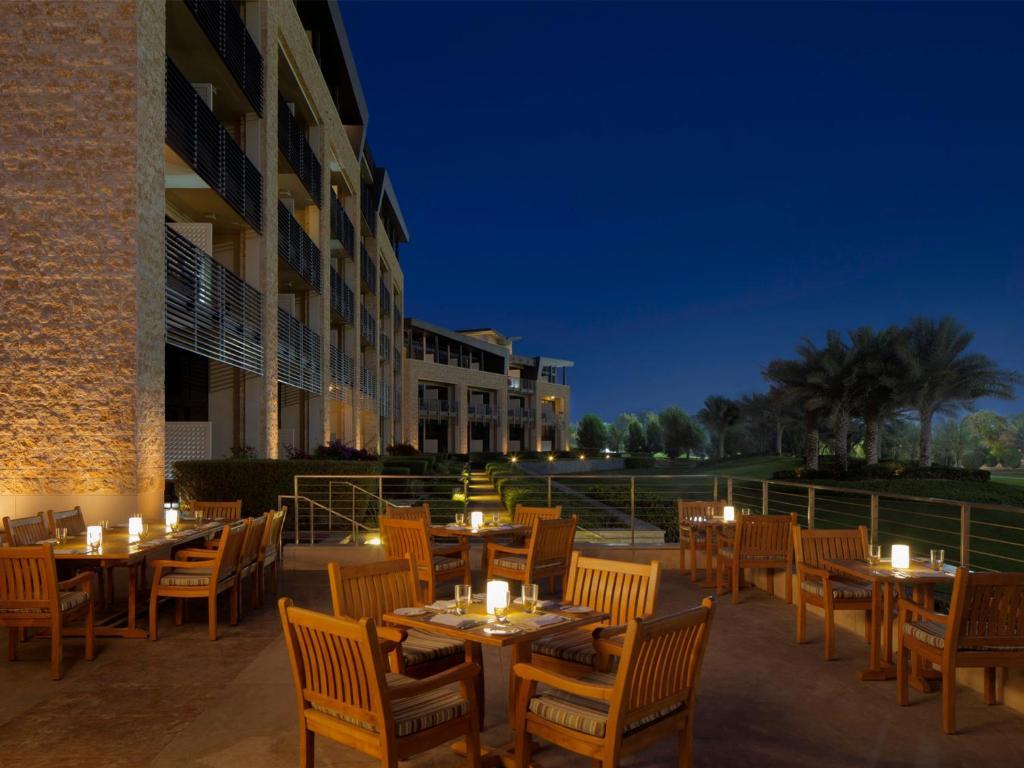 Outdoor seating area with table candles at the VOGO Abu Dhabi Golf Resort & Spa