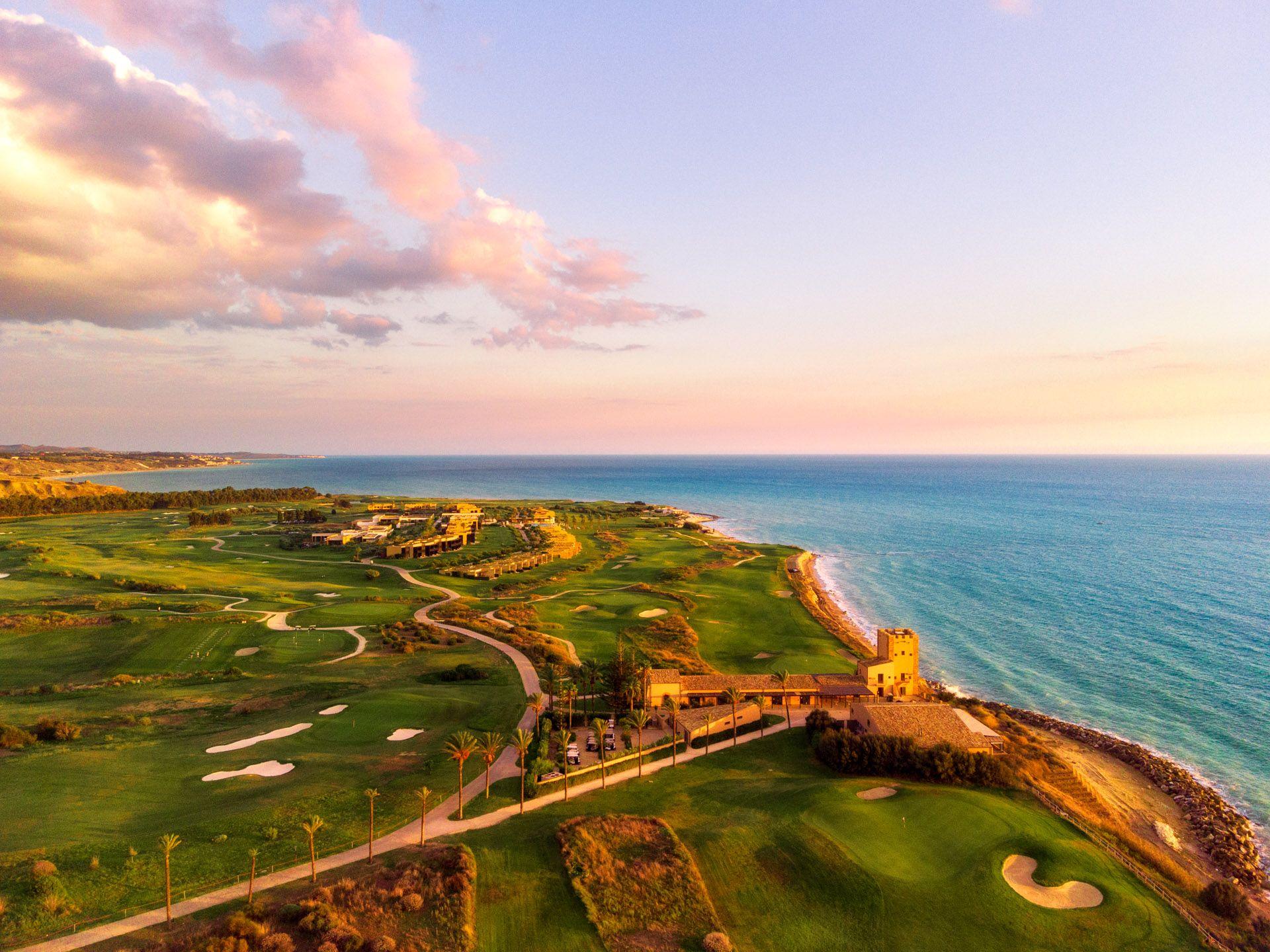 Sunset over the lush golf course with the ocean providing a stunning backdrop.