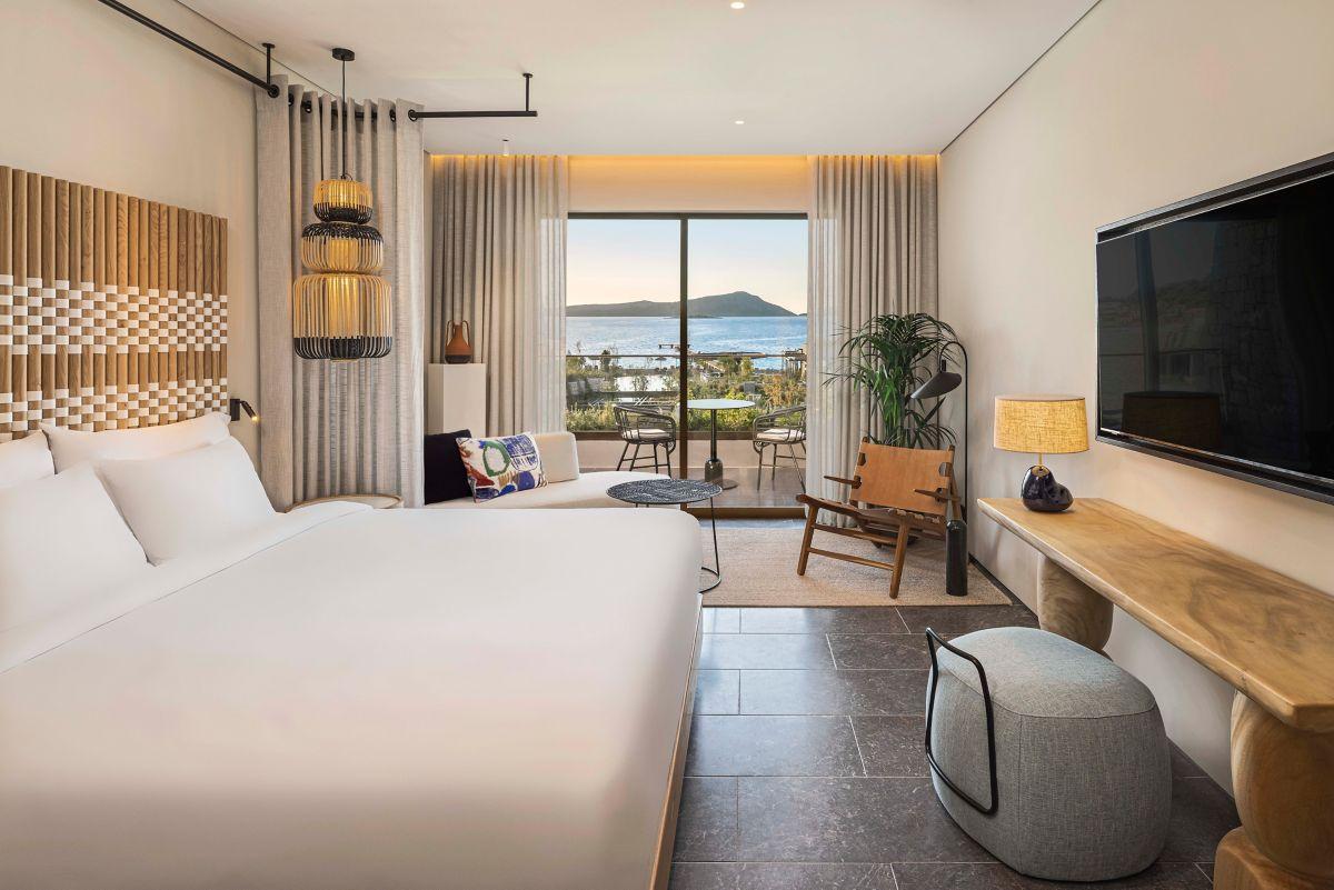 Double bed room at the hotel featuring a flat screen TV and balcony views of the sea