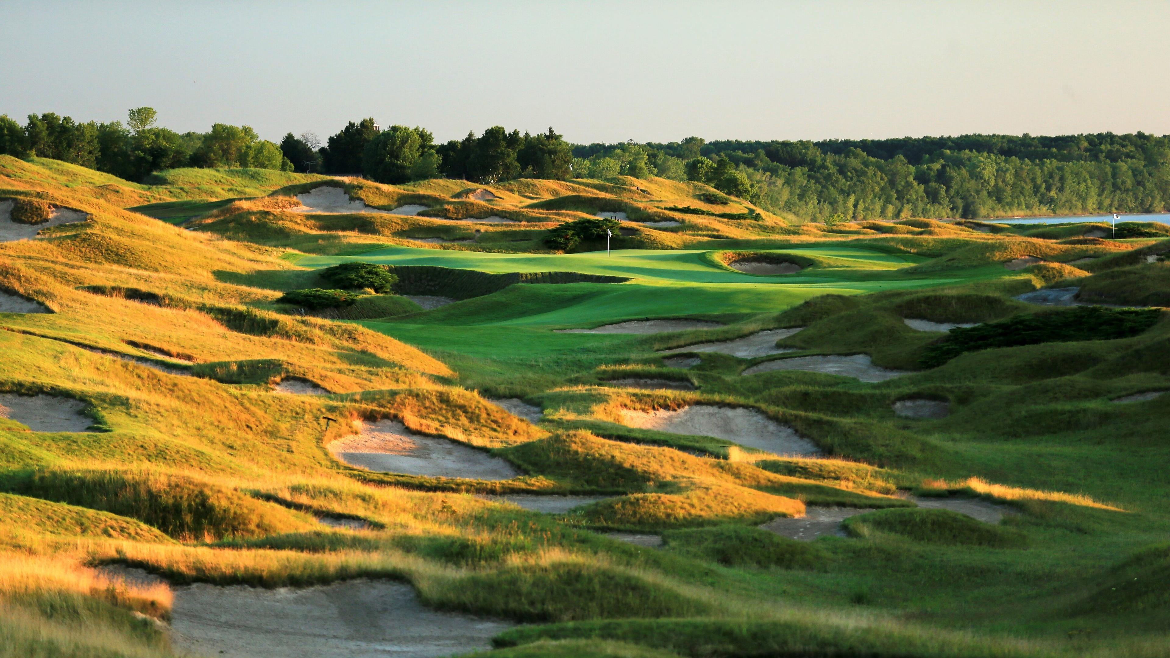 Countless small sand bunkers nestled into the surrounding rough and two large ones on the green