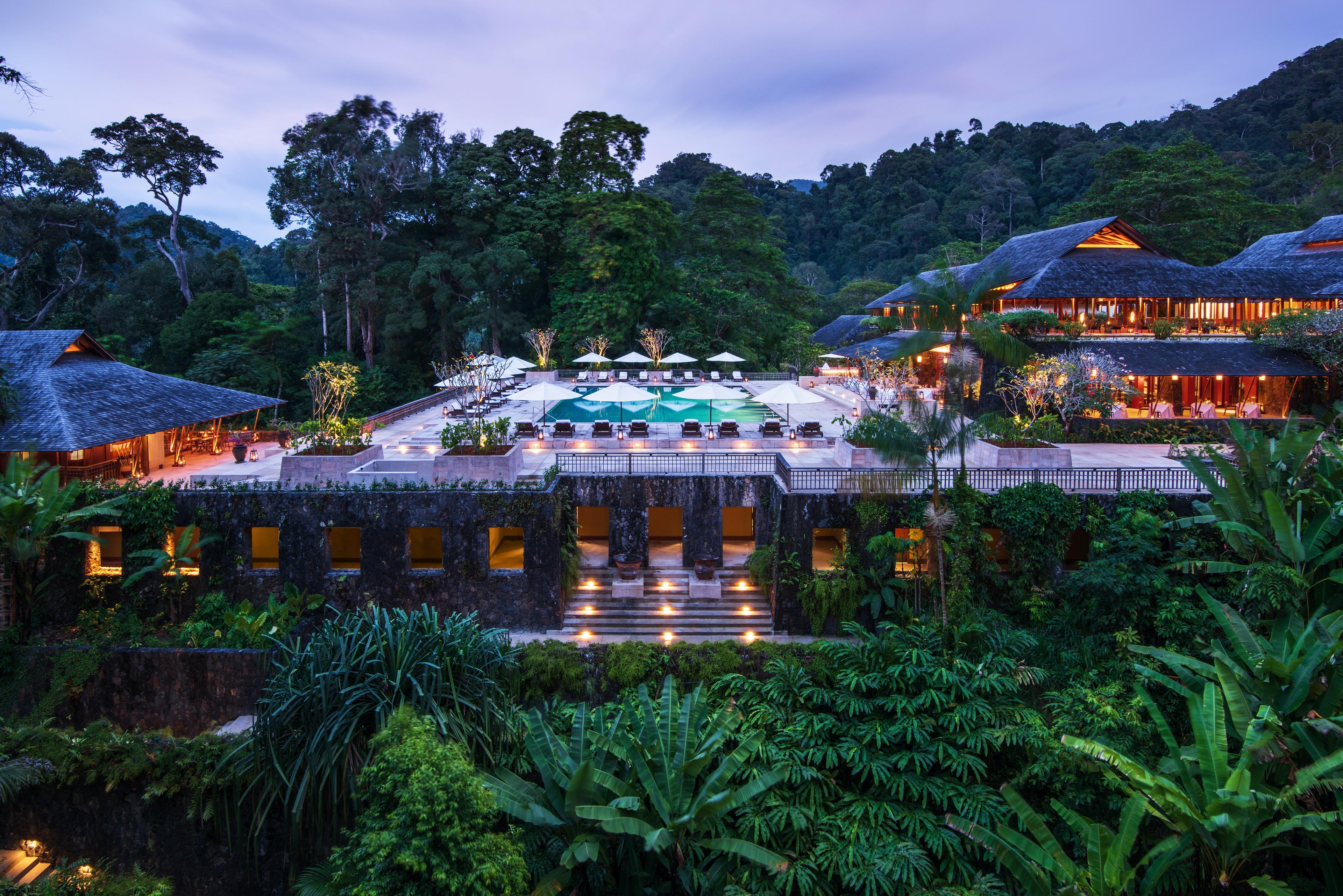 The Datai Langkawi hotel surrounded by nature on and around the building at evening
