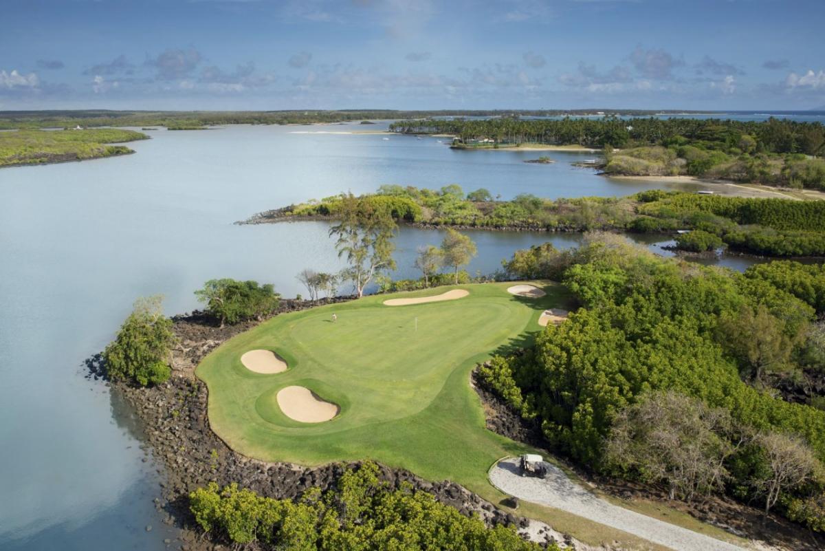 Aerial view of a green on the Legend Course with water behind