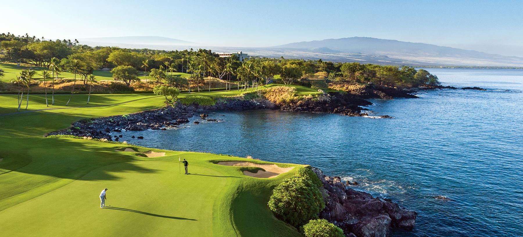 Aerial view of a cliffside green with sea views