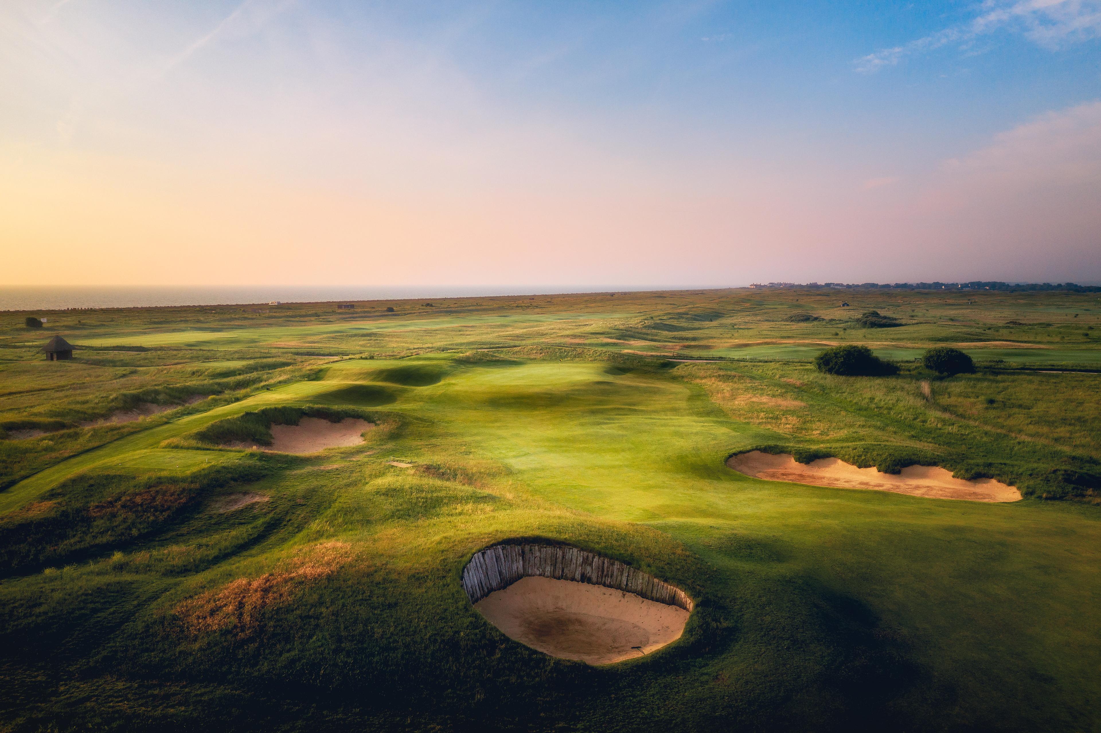 Overhead view of a well maintained fairway nestled with sand bunkers