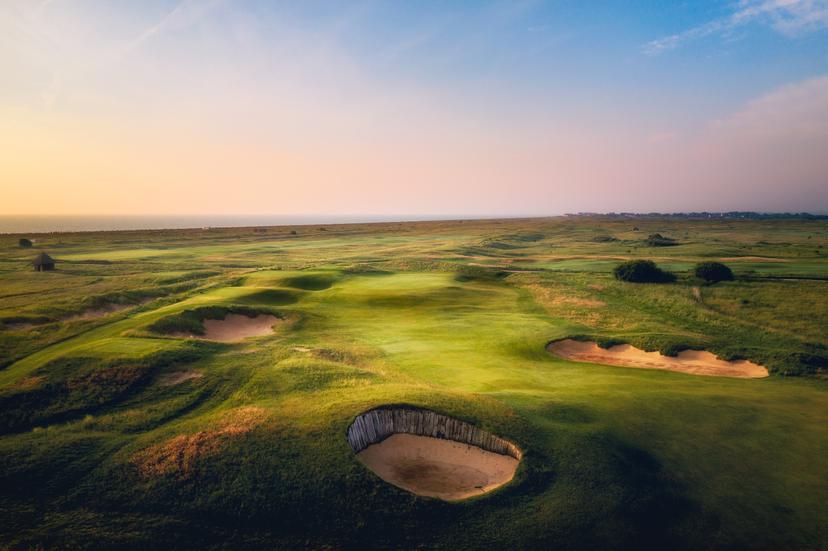 Overhead view of a well maintained fairway nestled with sand bunkers