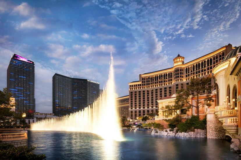 The resort at night being lit up with a grand fountain outside