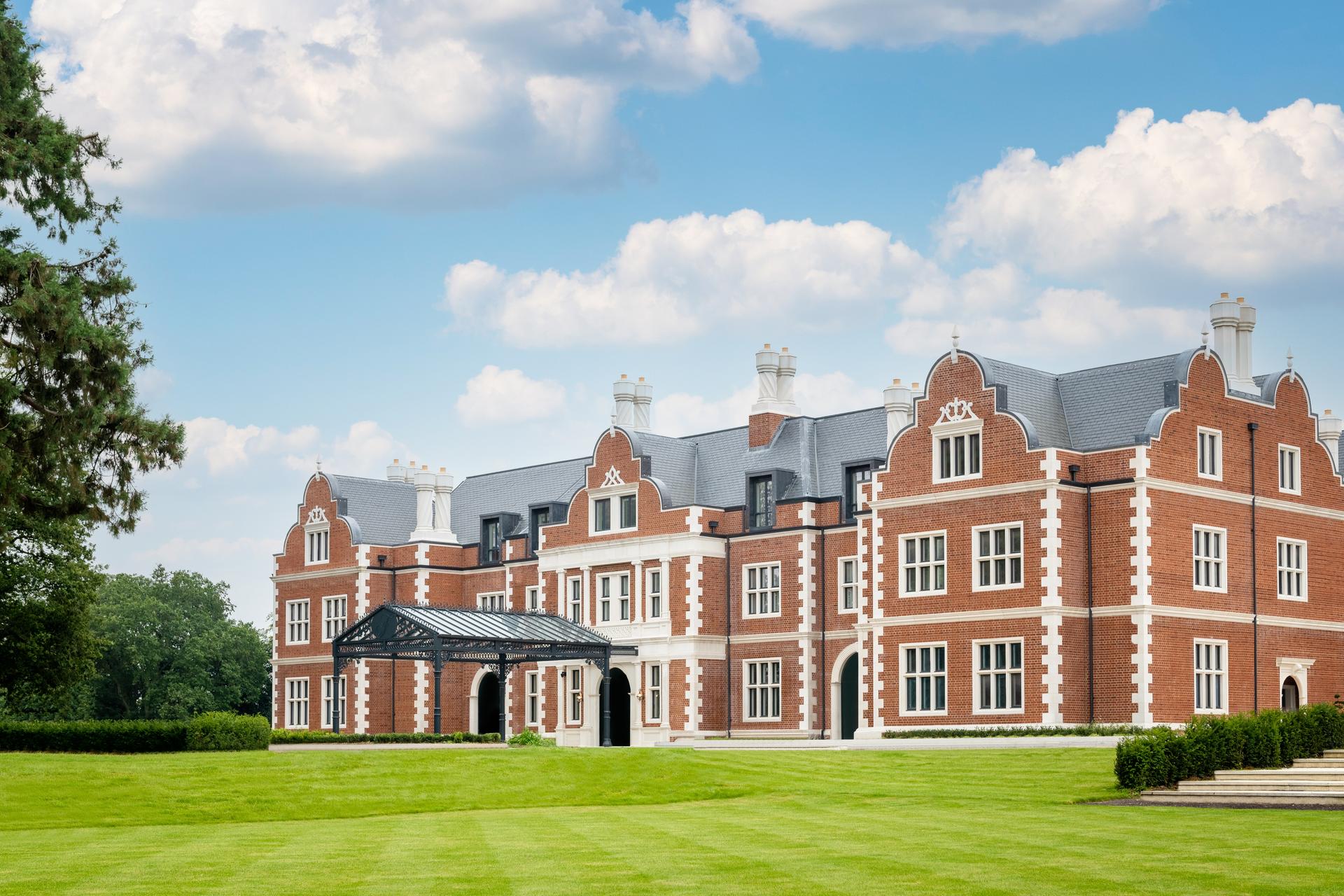 Exterior view of the Fairmont Windsor Park with manicured garden leading up to the grand building