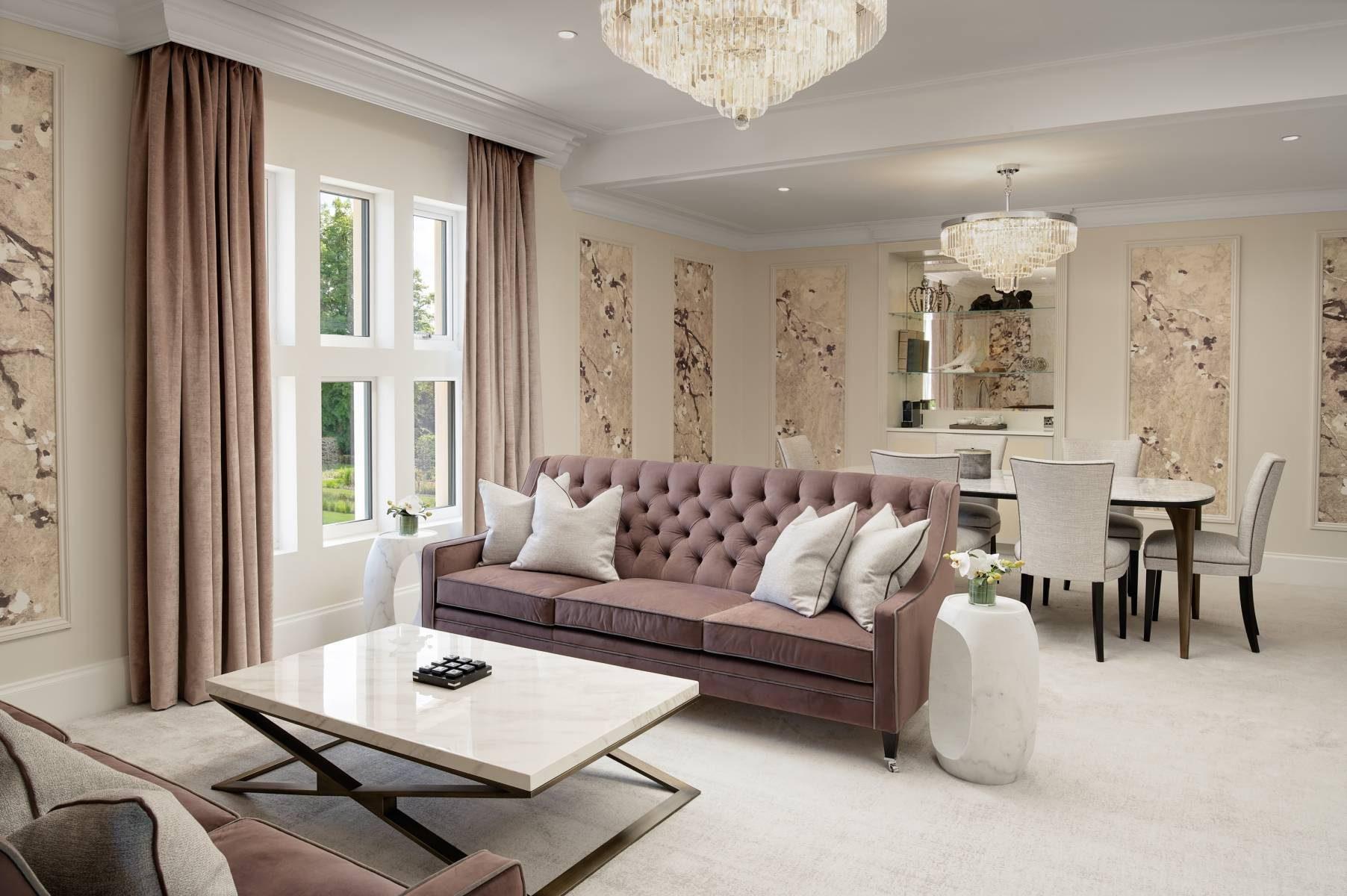 Luxurious sitting room with a modern cram design, dining table and sofa area as part of a suite at the hotel