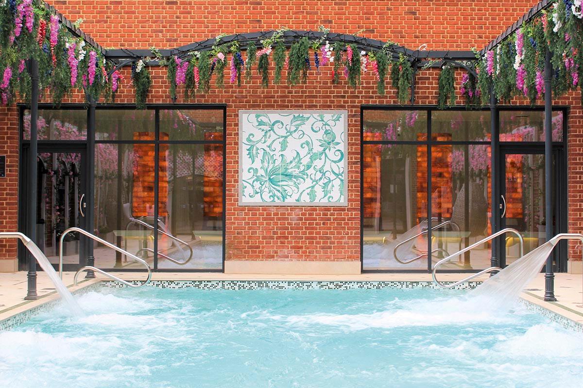 Outdoor swimming pool at the hotel with vibrant flowers surrounding