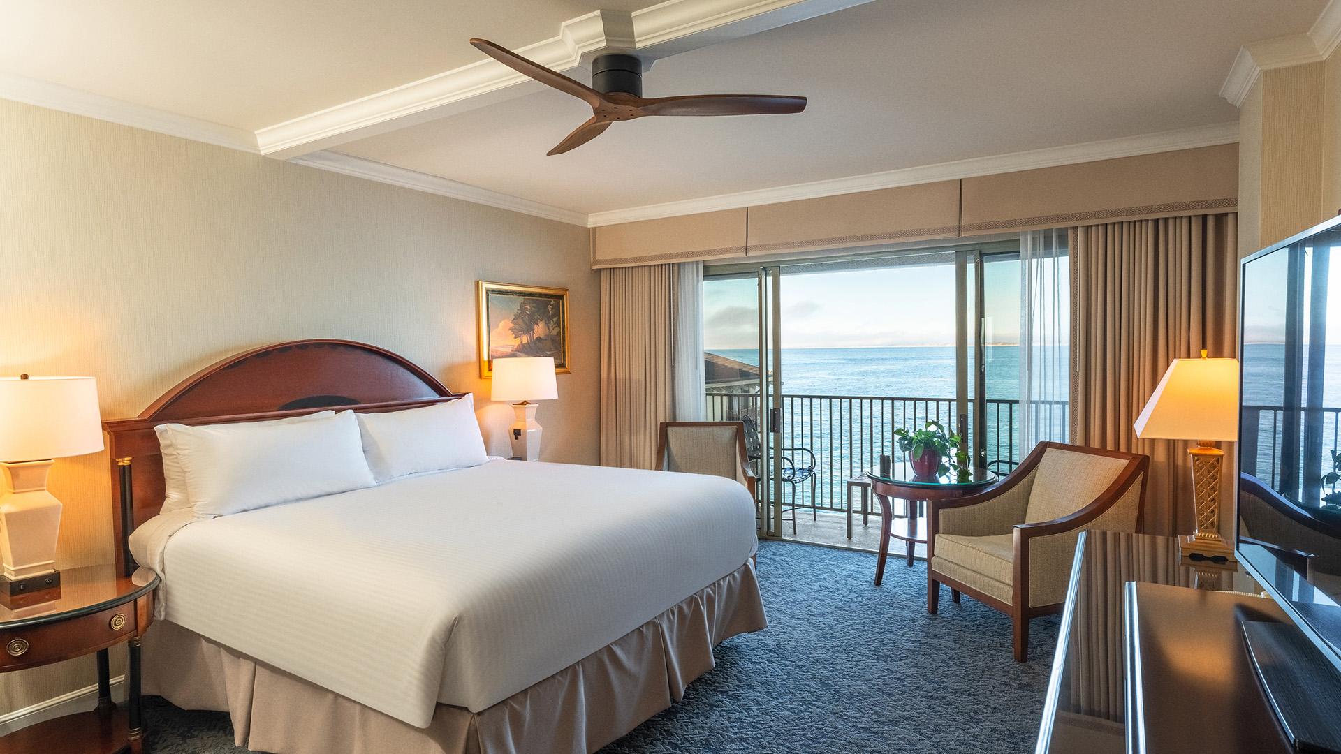A modern double bed room with balcony views of the ocean