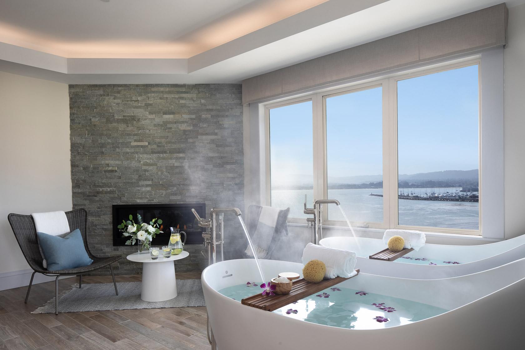 A luxurious twin bath as part of a suite at the hotel with window views of the ocean