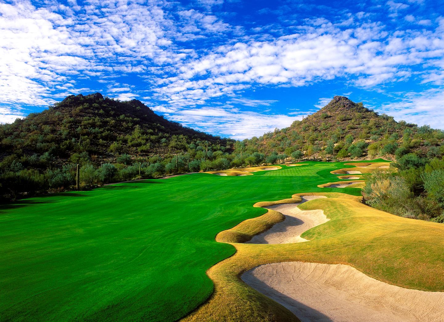A wide fairway surrounded by mountains