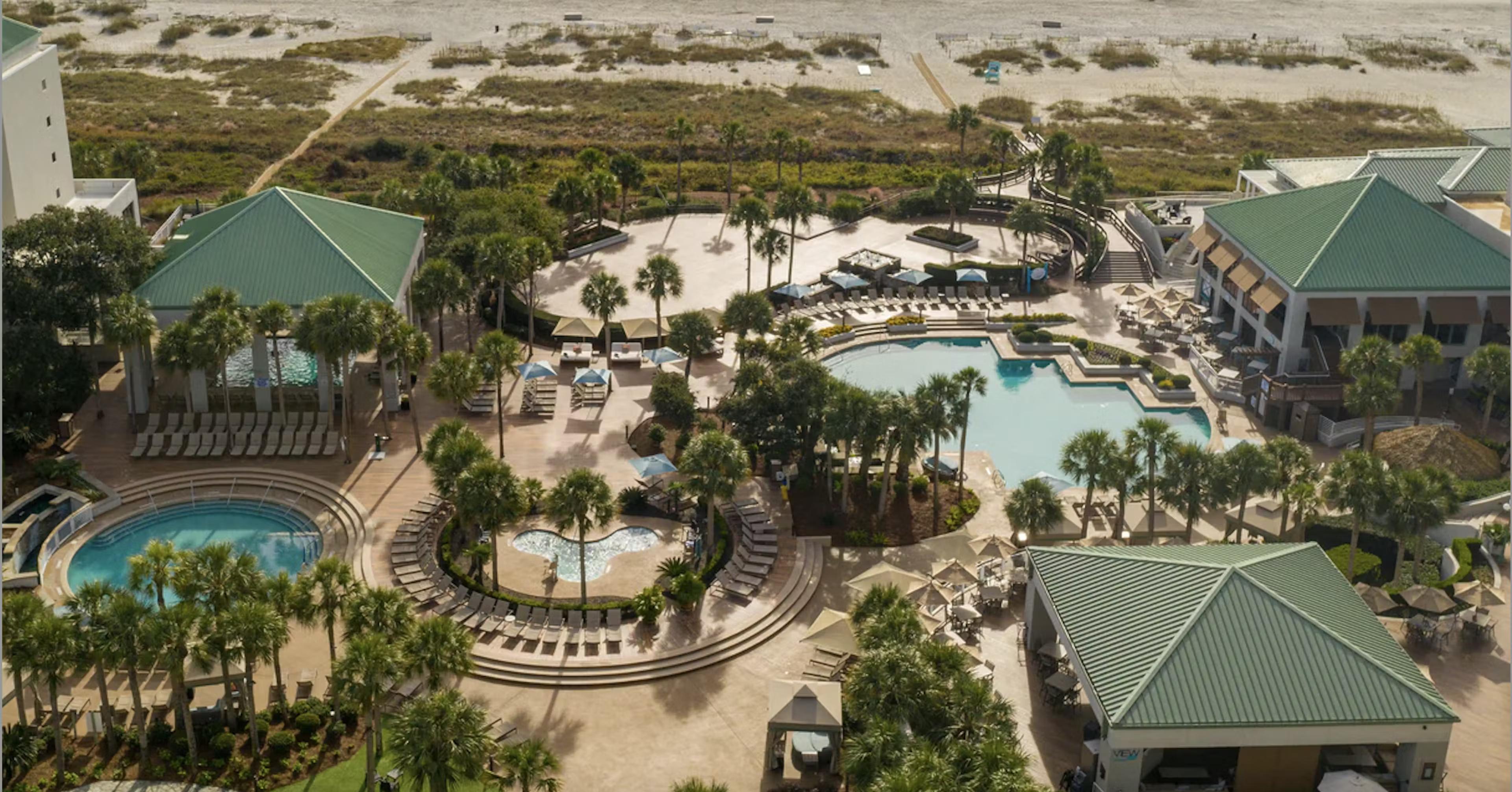 Overhead view of the outdoor swimming pool and cabanas at the resort