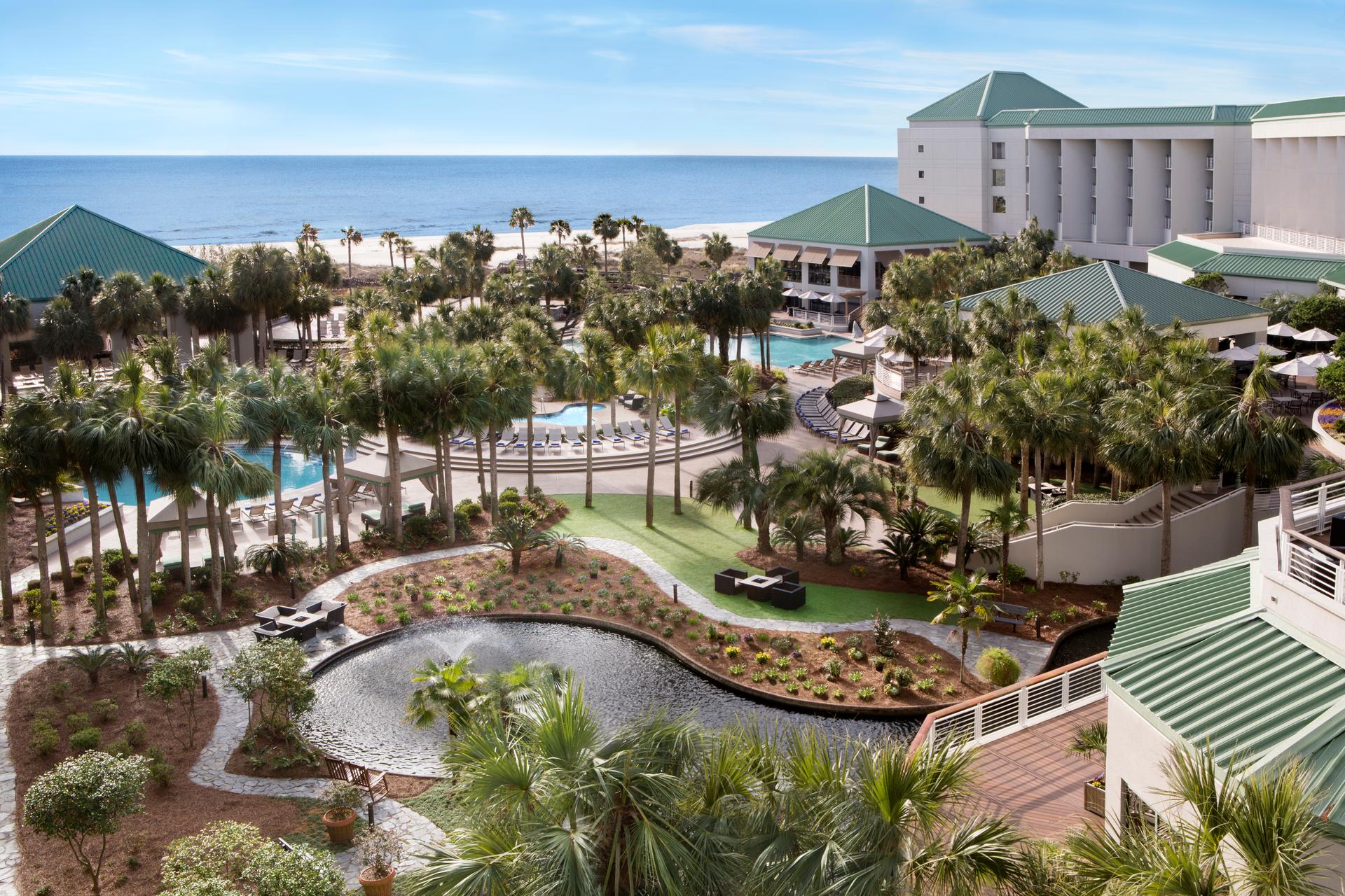 Exterior view of the outdoor swimming pool surrounded by palm trees